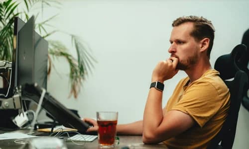 Healthcare coordinator tracking medical deliveries on a computer